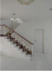 Elegant white staircase with decorative wrought-iron railings