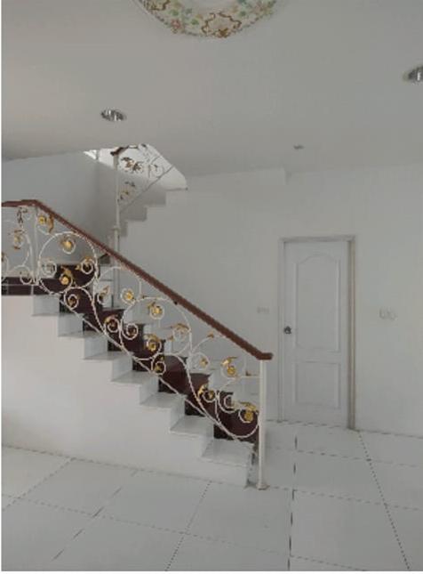 Elegant white staircase with decorative wrought-iron railings