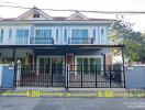 Townhouse exterior view with front yard and balcony