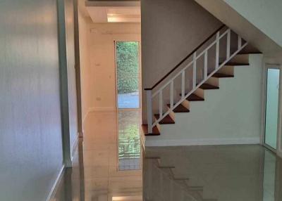 Modern interior with staircase and glossy tiled flooring