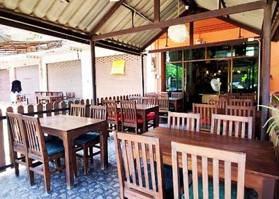 Spacious outdoor dining area with wooden tables and chairs