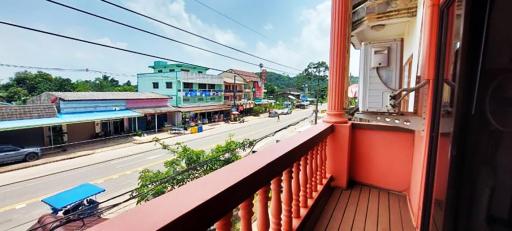 View from the balcony overlooking a street with local shops and vibrant community life