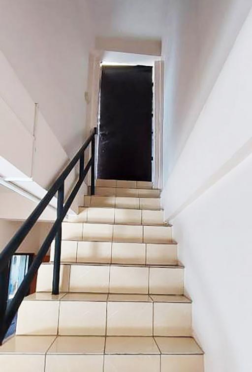 Bright staircase leading to an open door