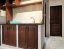 Compact kitchen with wooden cabinets and basic appliances