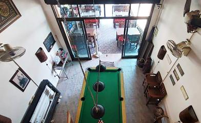 Spacious entertainment room with a pool table and eclectic decor