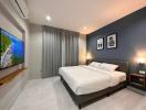 Modern bedroom with large bed and flat-screen TV