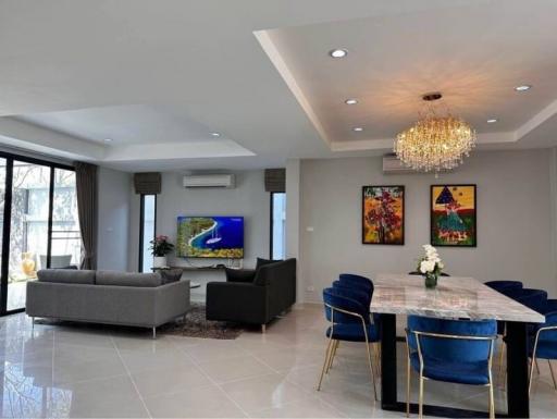 Spacious modern living room with dining area, large windows and contemporary decor