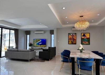 Spacious modern living room with dining area, large windows and contemporary decor