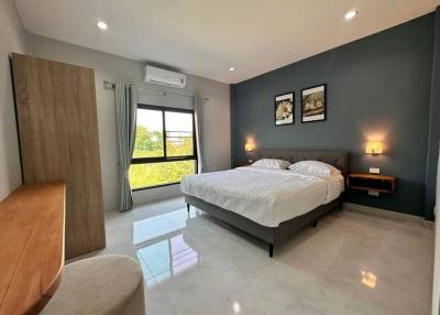 Modern bedroom with a large bed and artwork