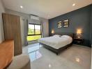 Modern bedroom with a large bed and artwork