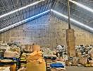 Spacious warehouse with high ceiling and storage sacks