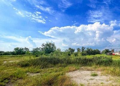 Expansive open lot under blue sky with clouds