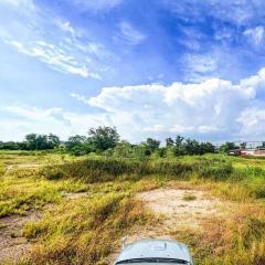 Spacious open land with clear skies and greenery