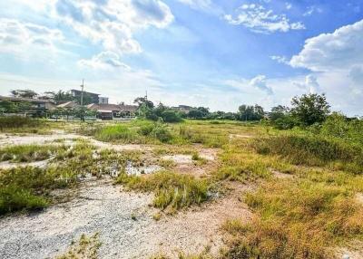 Spacious empty land with open blue sky and potential for development