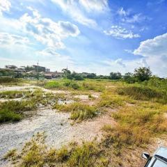 Spacious empty land with open blue sky and potential for development