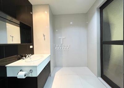 Modern spacious bathroom with dual sinks and large mirror