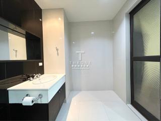 Modern spacious bathroom with dual sinks and large mirror