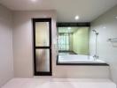 Modern bathroom with a bathtub and glass shower partition