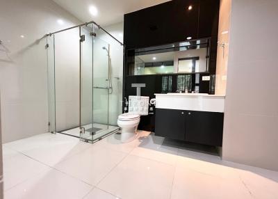 Modern bathroom with glass shower enclosure and double vanity
