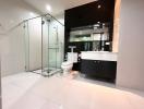 Modern bathroom with glass shower enclosure and double vanity