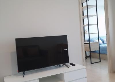 Clean and modern living room with wall-mounted TV and air conditioner