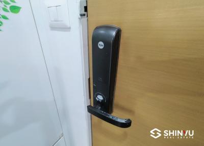 Modern digital lock on a wooden front door of an apartment