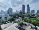 Panoramic city view from a high-rise apartment balcony