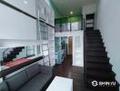 Modern living room with high ceiling and staircase