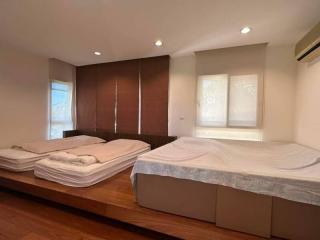 Spacious bedroom with two beds and wooden flooring