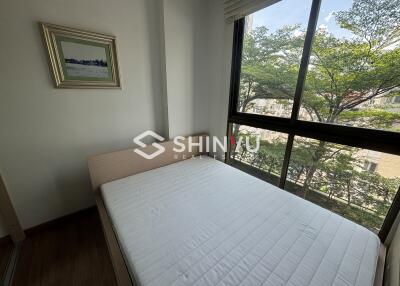 Bedroom with a single bed and large window