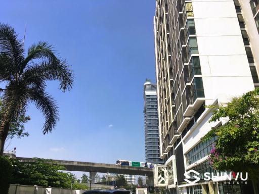 Modern residential high-rise building with a clear blue sky