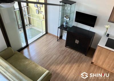 Modern living room with balcony access and hardwood floors