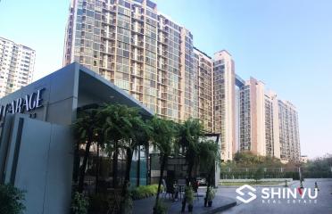 Modern high-rise residential complex with landscaped entrance