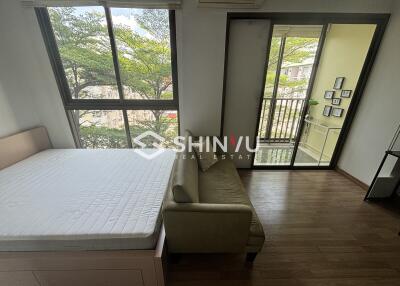 Bedroom with large windows and a small balcony