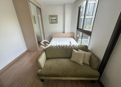 Bedroom with a green couch and a bed