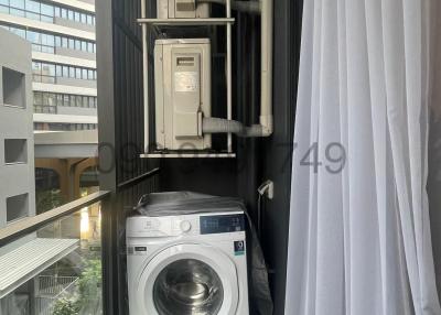 Compact laundry area with a washing machine and stacked dryer