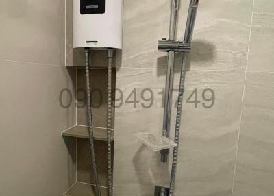 Modern bathroom with wall-mounted water heater and handheld shower head