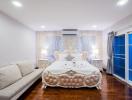 Elegantly furnished bedroom with hardwood floors and modern amenities