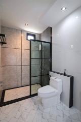 Modern bathroom with glass shower and elegant tiling