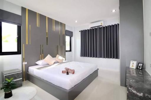 Modern bedroom with stylish interior design and queen-sized bed