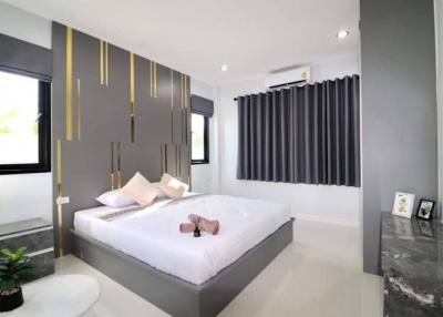 Modern bedroom with stylish interior design and queen-sized bed