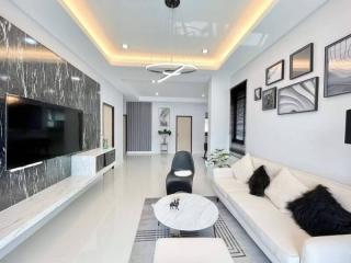 Modern living room with elegant furnishings and designed ceiling