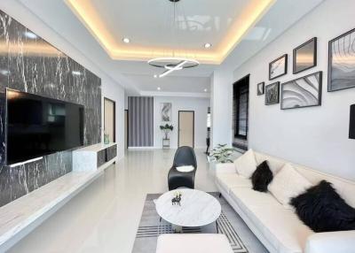 Modern living room with elegant furnishings and designed ceiling