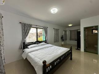 Spacious and well-lit bedroom with a king-sized bed and modern amenities