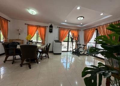 Spacious living room with fitness equipment and dining area