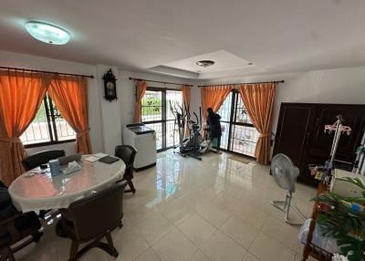 Bright spacious living room with a dining area and exercise equipment