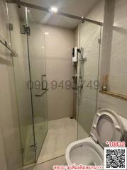 Modern bathroom with glass shower enclosure and white tiles