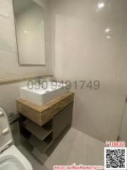 Modern bathroom with white tiles and a sleek sink