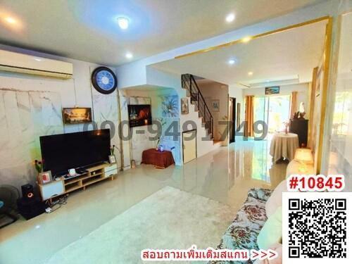 Spacious living room with modern amenities and staircase