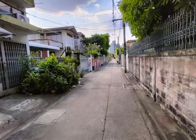 Quiet residential street with sidewalks and surrounding houses